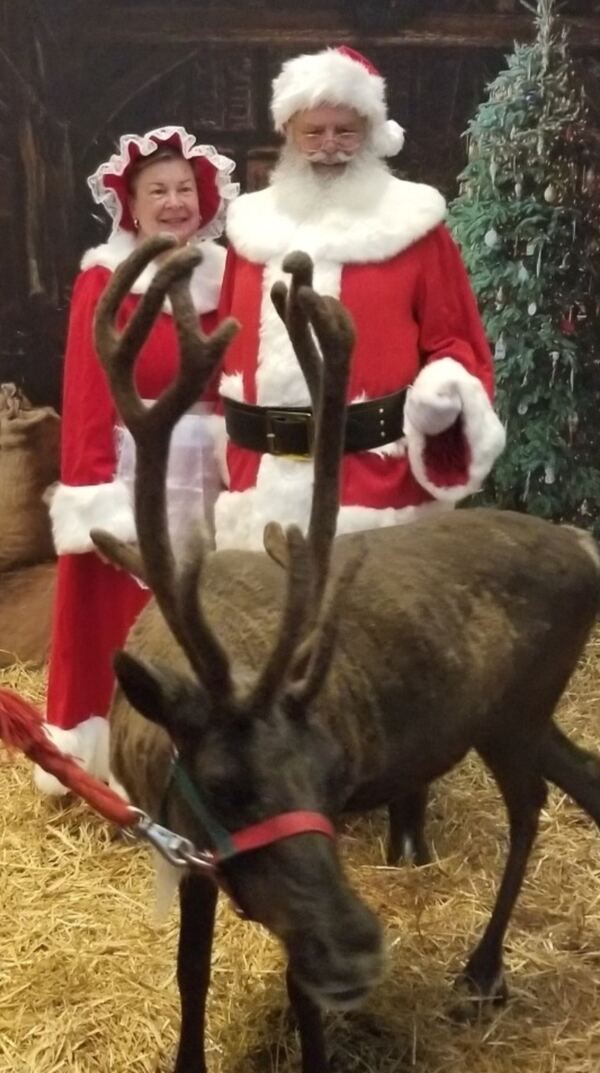 Santa and Mrs. Claus with a live reindeer