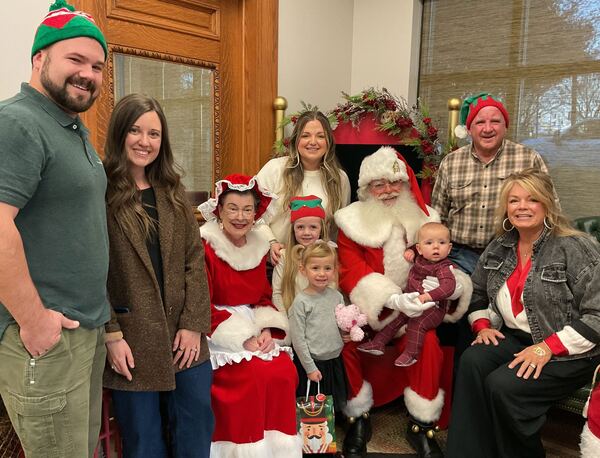 Family gathered with Santa and Mrs. Claus
