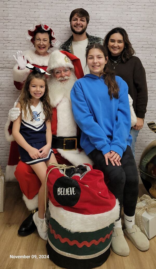 Family with Santa Truette and his toy bag