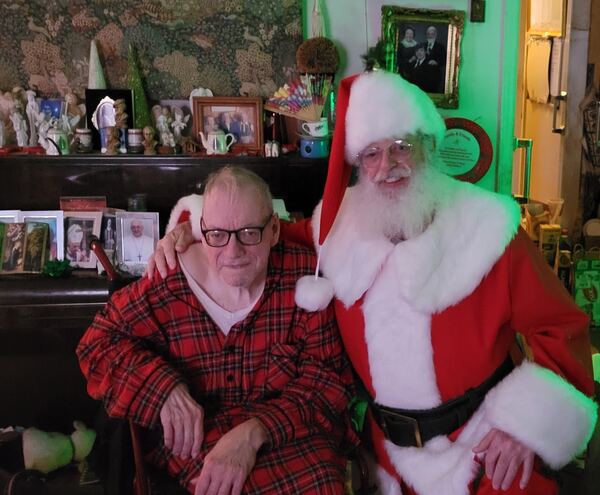 Man in plaid pajamas with Santa Truette