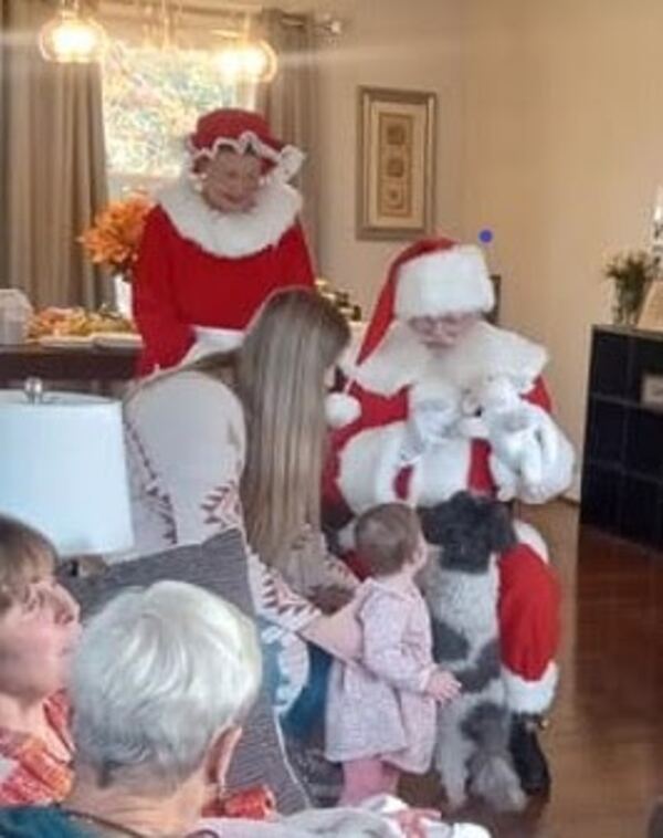 Santa and Mrs. Claus visiting a family at home