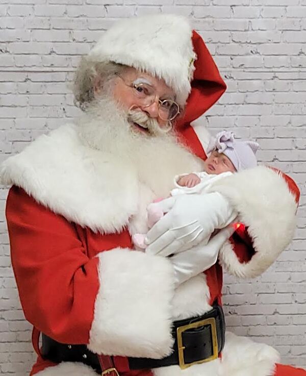 Santa Truette cradling a newborn baby