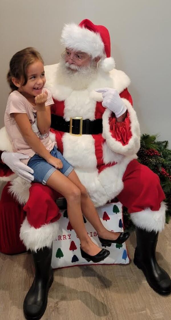 Young girl sitting on Santa's knee