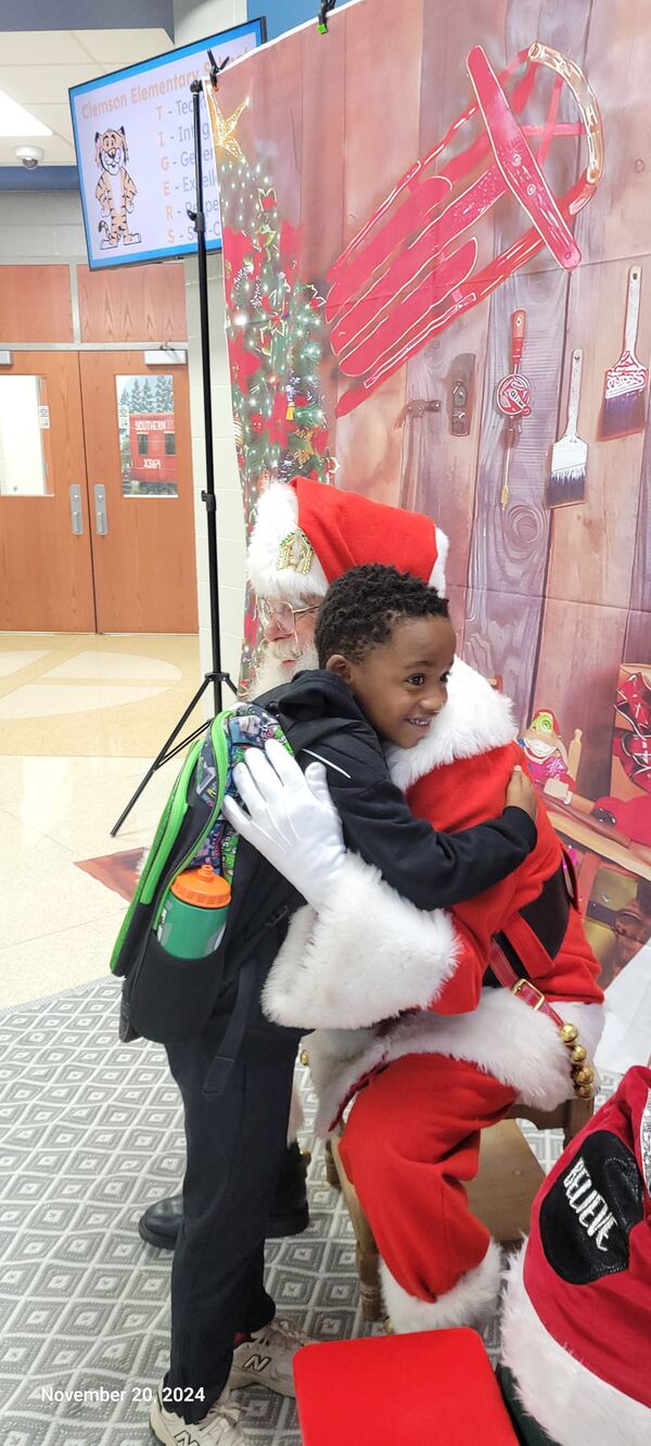 Child hugging Santa Truette