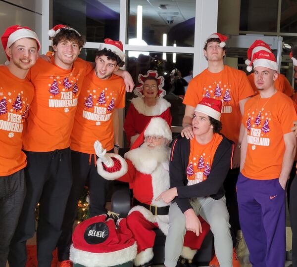 Clemson students in orange shirts with Santa