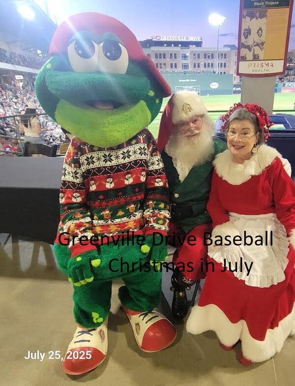 Santa and Mrs. Claus with the Greenville Drive mascot at Christmas in July