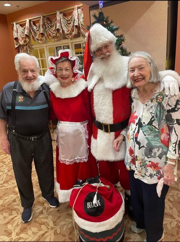 Santa and Mrs. Claus with residents of a senior living community