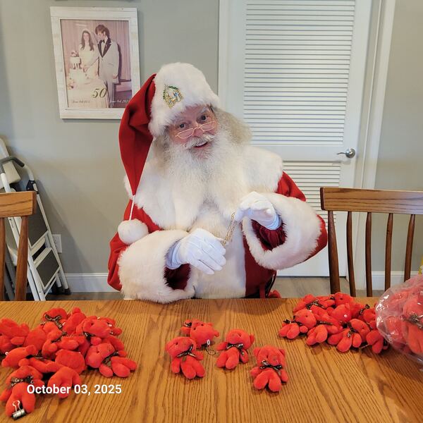 Santa Truette with a table full of red bows