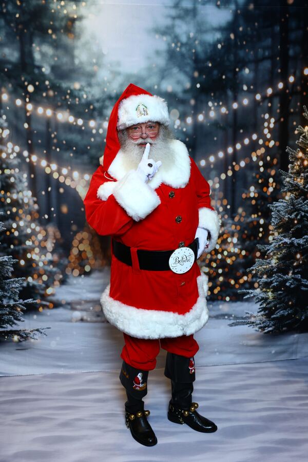 Santa Truette going “shh” in a snowy forest scene