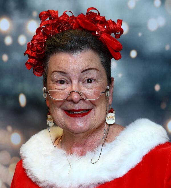 Close-up portrait of Mrs. Claus Nancy with a red bow in her hair