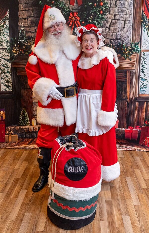 Santa Truette and Mrs. Claus Nancy with Santa's toy bag