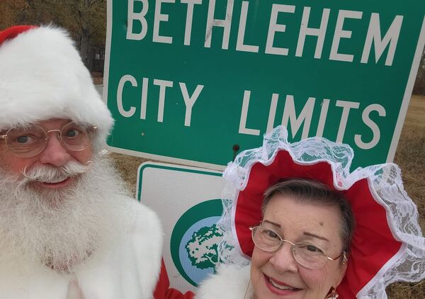 Santa Truette and Mrs. Claus Nancy at the Bethlehem city limits sign