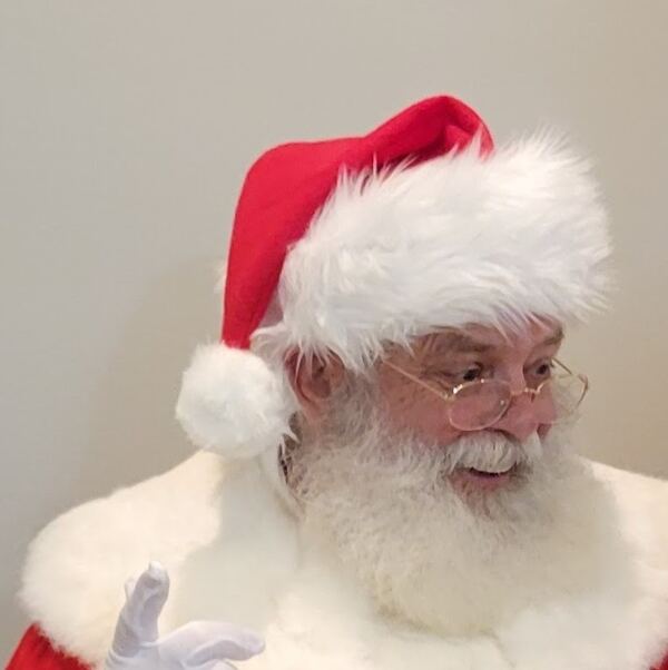 Santa Truette in his red hat and gold glasses